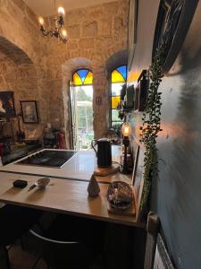a kitchen with a counter top with a stove and windows at נרקיס NARKIS in Jerusalem