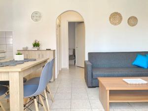 a living room with a couch and a table at Mokamvilia House in Ammouliani +7 photos