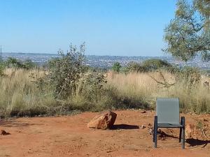 a chair sitting in the middle of a dirt field at KGOLA SAFARIS in Rosslyn