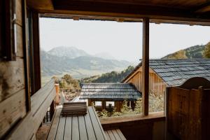 a view from the balcony of a cabin with mountains at Natur- und Wellnesshotel Höflehner in Haus im Ennstal
