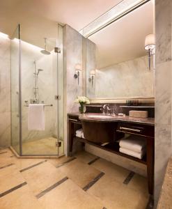 a bathroom with a sink and a shower at JW Marriott Hotel Chongqing in Chongqing