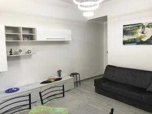 a living room with a couch and a table at "DOMUS LEONE" - Nel Borgo di Capri Leone in Capri Leone