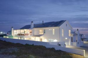 a house with solar panels on the roof at Maki-Saki Boutique Self-Catering Accommodation in Yzerfontein