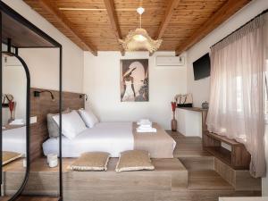 a bedroom with a bed and a chandelier at Lavender Suite with Sea View - Beach at your Doorstep in Platanias