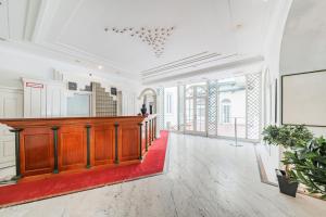 une grande chambre avec un podium en bois dans un bâtiment dans l'établissement Self-Check-In Hotel Adlon, à Vienne