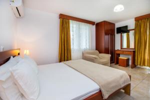 A bed or beds in a room at Kiriakos Holiday Home