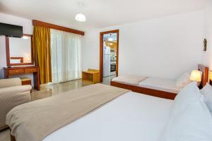 A bed or beds in a room at Kiriakos Holiday Home