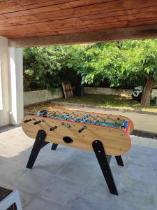 a wooden table with toys on top of it at Villa A CASA DI FICU proche d'Ajaccio avec piscine et jacuzzi in Peri