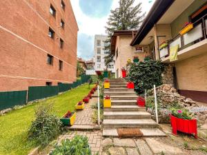 a stairway with colorful pots of flowers and plants at Hi Skopje Hostel in Skopje