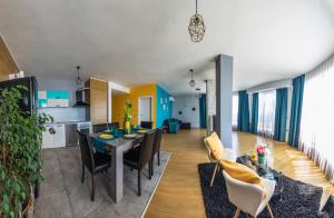 a kitchen and living room with a table and chairs at GM Apart in Varna City