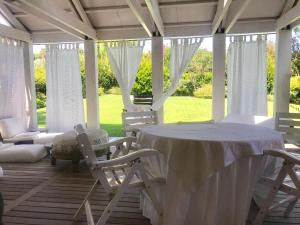 a white table and chairs on a porch at VILLA CAMPAGNA in Isola Albarella