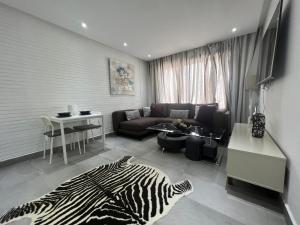 a living room with a zebra print rug and a couch at Studio luxueux et contemporain in Casablanca