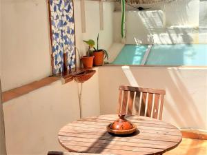 a wooden table with a tea pot sitting on a chair at ApartEasy - Private terrace, TURO PARK in Barcelona