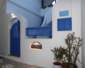 a blue door and a sign on a building at Pension Barbara in Katapola