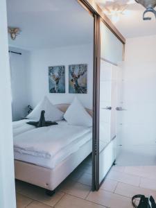 a bedroom with a bed and a mirror at Ferienwohnung Bergjuwel in Fischen