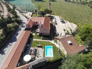 an aerial view of a house with a swimming pool at Quinta de Anterronde in Arouca