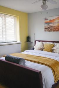 a bedroom with a large bed with a blanket on it at Very Peaceful Semi Detached Home Stoke on Trent in Rough Close