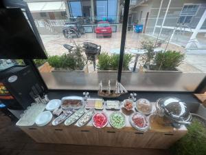 a table with plates of food on top of it at Hotel Tramonto Vlore in Vlorë