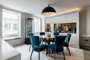 comedor con mesa y sillas azules en Stunning central Bath Apartment en Bath