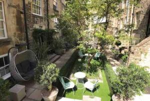 a small garden with chairs and tables on a balcony at Stunning central Bath Apartment in Bath
