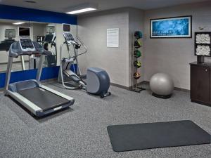 a fitness room with a treadmill and a gym at Sonesta ES Suites St. Louis Westport in Maryland Heights