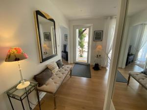 a living room with a couch and a mirror at Gite-le-7 in Brive-la-Gaillarde