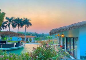 a resort with a view of a pool and palm trees at Eagle Bavi Resort in Ba Vì