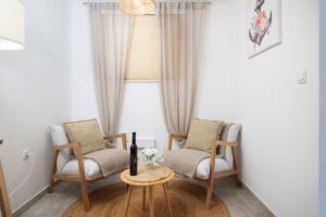 a living room with two chairs and a table at Apartments and rooms Jakić in Medulin