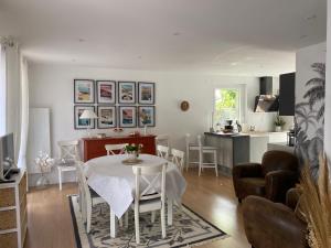 a dining room and kitchen with a table and chairs at Gite-le-7 in Brive-la-Gaillarde