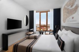 A bed or beds in a room at AKKA Lush Hotel Taksim