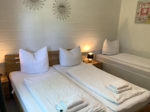 a bedroom with two beds with towels on them at Blockhäuser Fewo4 Harzblick in Braunlage