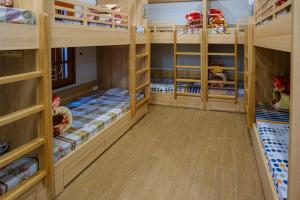 a childrens room with bunk beds and wooden floors at Bavi Homestead in Ba Vì