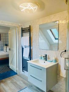 a bathroom with a sink and a mirror at Rowantreebank Bed and Breakfast in Arrochar