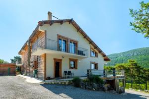 an exterior view of a house with mountains in the background at Domaine De La Plaine in Caille