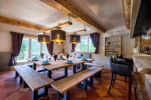 a dining room with a long wooden table and chairs at Domaine De La Plaine in Caille