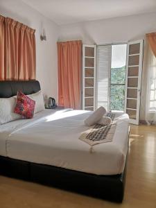 a large white bed in a room with a window at 5 Twenty @ Ampang Hilir in Kuala Lumpur