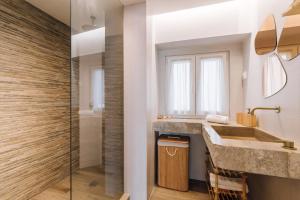 a bathroom with two sinks and a shower at Casa do Tio Farinha by RNvillage in Sesimbra +24 photos
