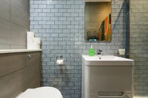 a bathroom with a white toilet and a sink at The Studio House - Crouch End in London