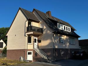 a house with a staircase on the side of it at Ferienwohnung am See No.1 in Borken
