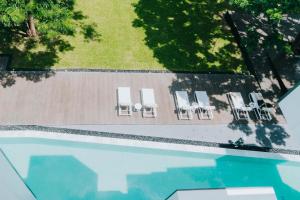an overhead view of a swimming pool with lounge chairs at Riva Vista Riverfront Resort Chiang Rai in Chiang Rai