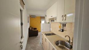 a kitchen with a sink and a refrigerator at Apartments Val Maslina in Utjeha