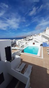 a view of a swimming pool on top of a building at The White Dragos with Ocean view in Tías