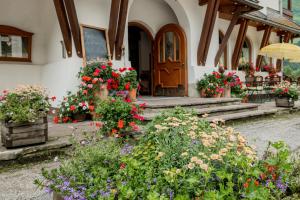 ein Haus mit Blumen und Pflanzen davor in der Unterkunft Gasthof Schwarzer Adler in Steeg