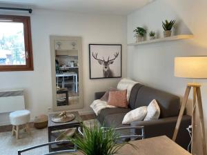 a living room with a couch and a deer on the wall at Les Deux Alpes in Les Deux Alpes