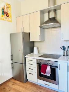 a kitchen with a stove and a refrigerator at Super Apartment Old town in Klaipėda