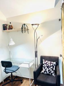 a room with a desk and a chair and a lamp at Super Apartment Old town in Klaipėda