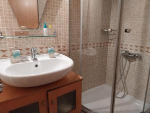 a bathroom with a sink and a shower at Cozy apartment close to the sea in Perea