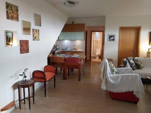 a living room and kitchen with a couch and a table at Cozy apartment close to the sea in Perea
