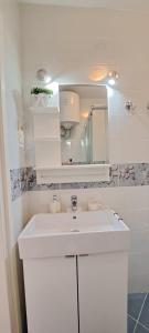 a bathroom with a white sink and a mirror at MKR Family Room in Zagreb +37 photos