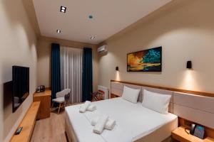 a hotel room with a bed and a tv at Hotel Marwa Tashkent Pool&Spa in Tashkent